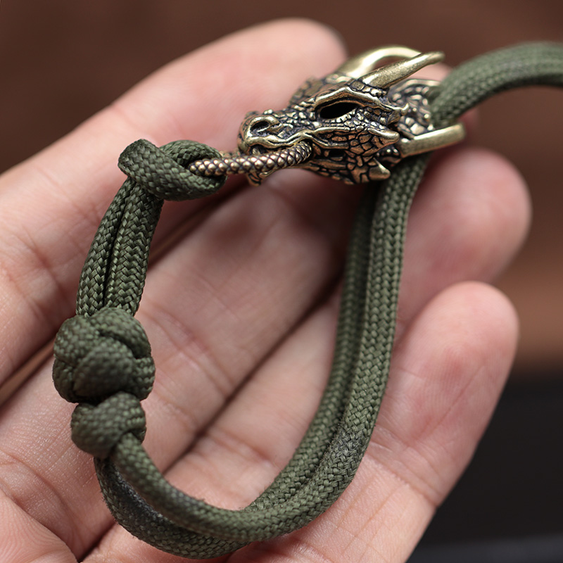 หัวมังกรทองเหลืองหัวเข็มขัด ED - Paracord Survival Bracelet บทวิจารณ์และราคา
