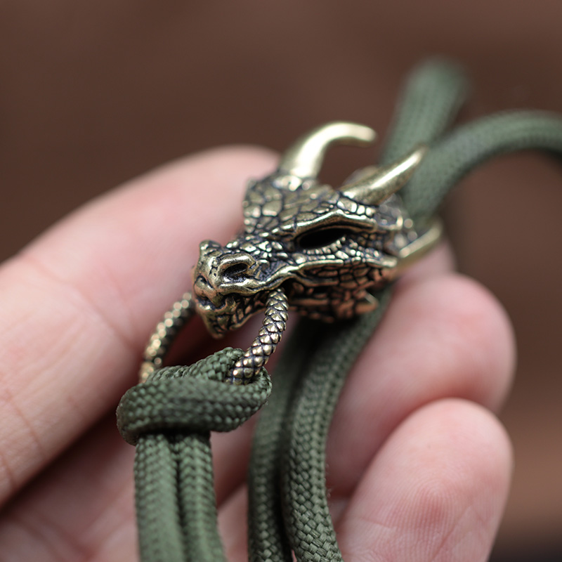 หัวมังกรทองเหลืองหัวเข็มขัด ED - Paracord Survival Bracelet บทวิจารณ์และราคา